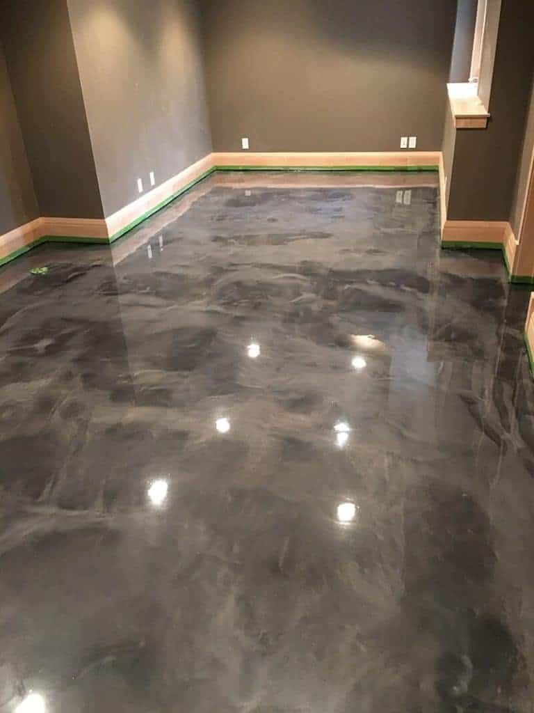 "High-gloss polished concrete floor in a modern Minnesota basement, showcasing sleek, durable, and stylish flooring by expert concrete contractors."